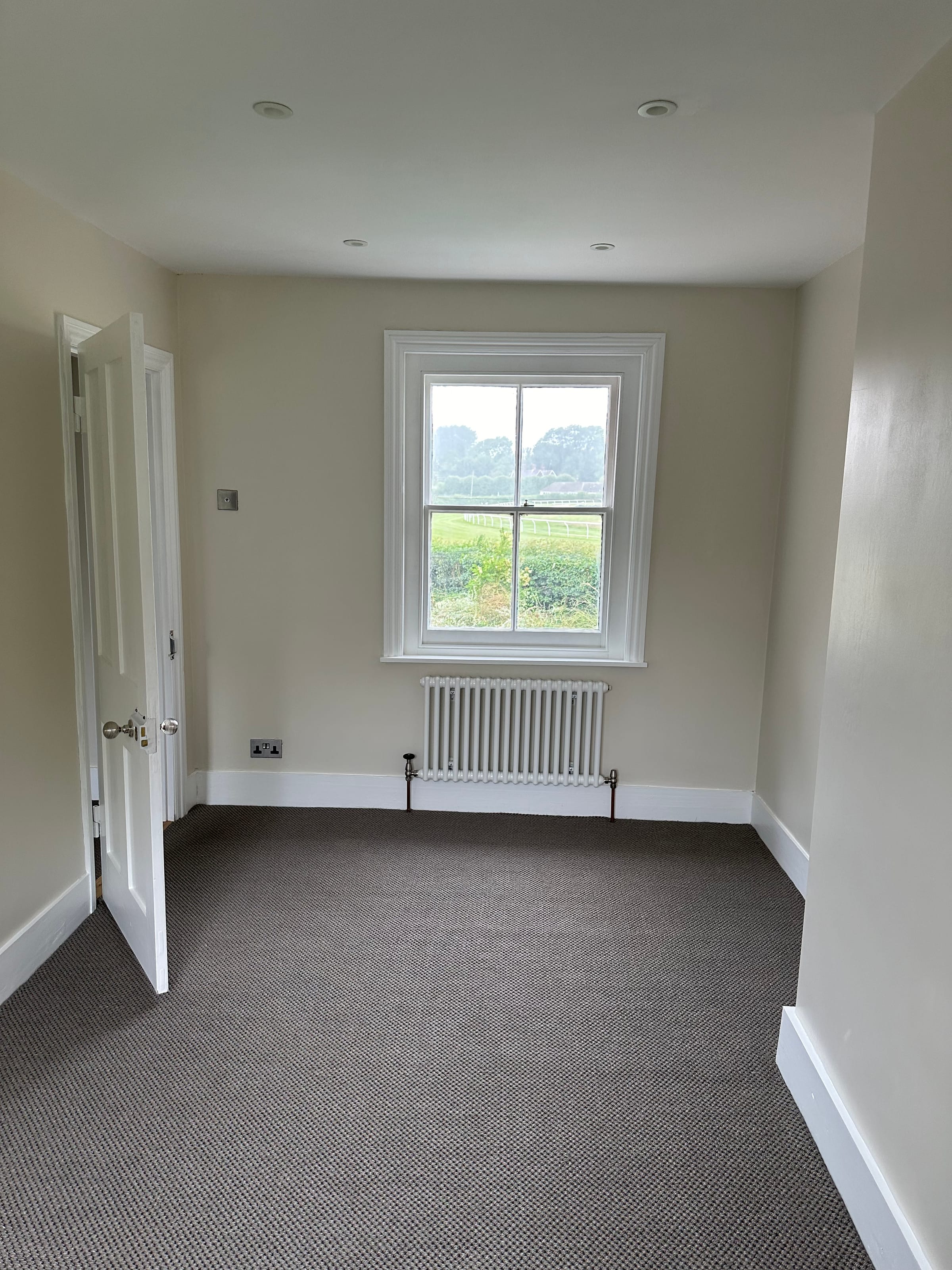 Finished bedroom with fresh plaster, decoration and new carpet