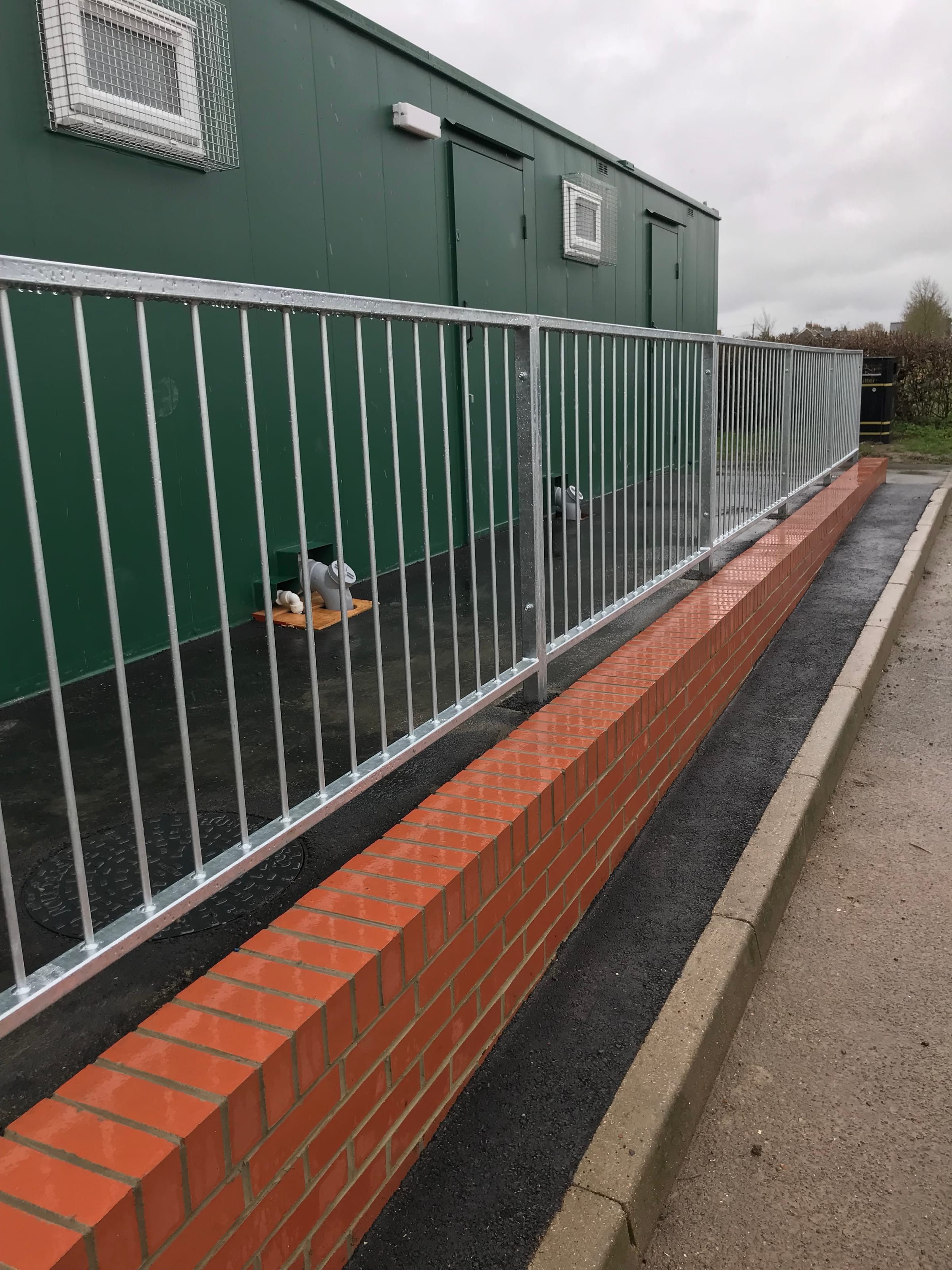 Brick retaining wall with galvanised railings