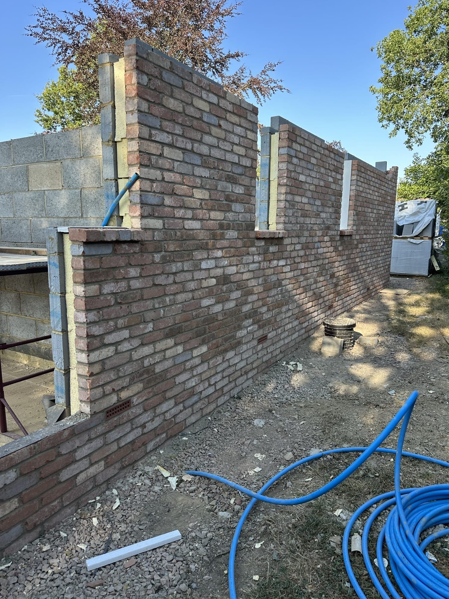 Brickwork wall being built up course by course