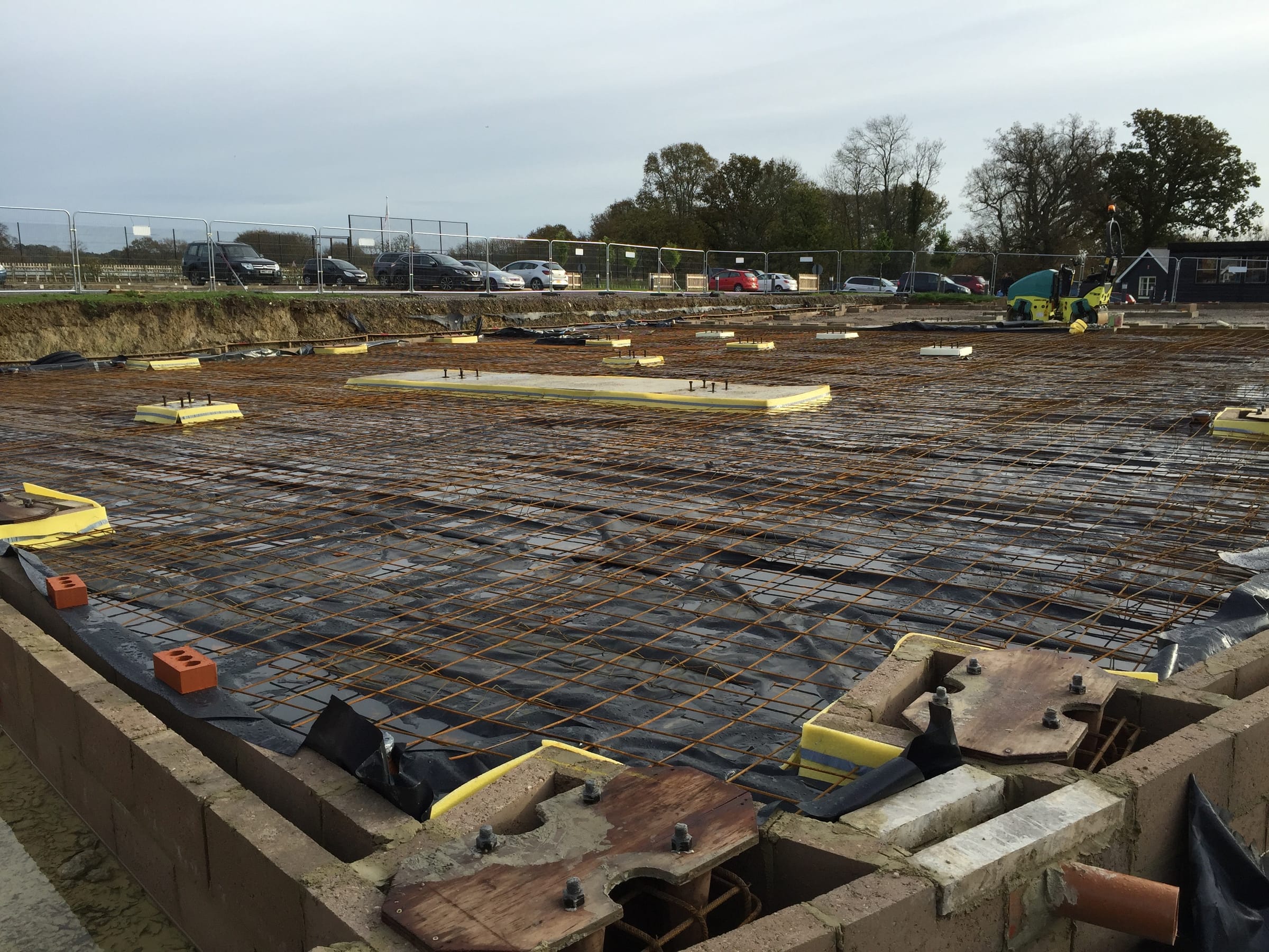 Large commercial concrete slab with reinforcement mesh and holding-down bolts