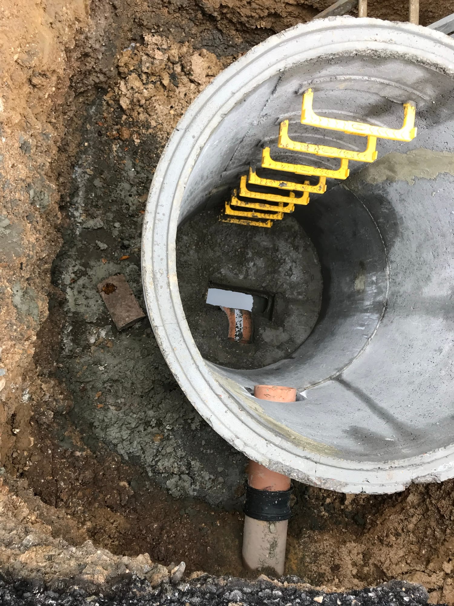 Precast drainage chamber ring being installed