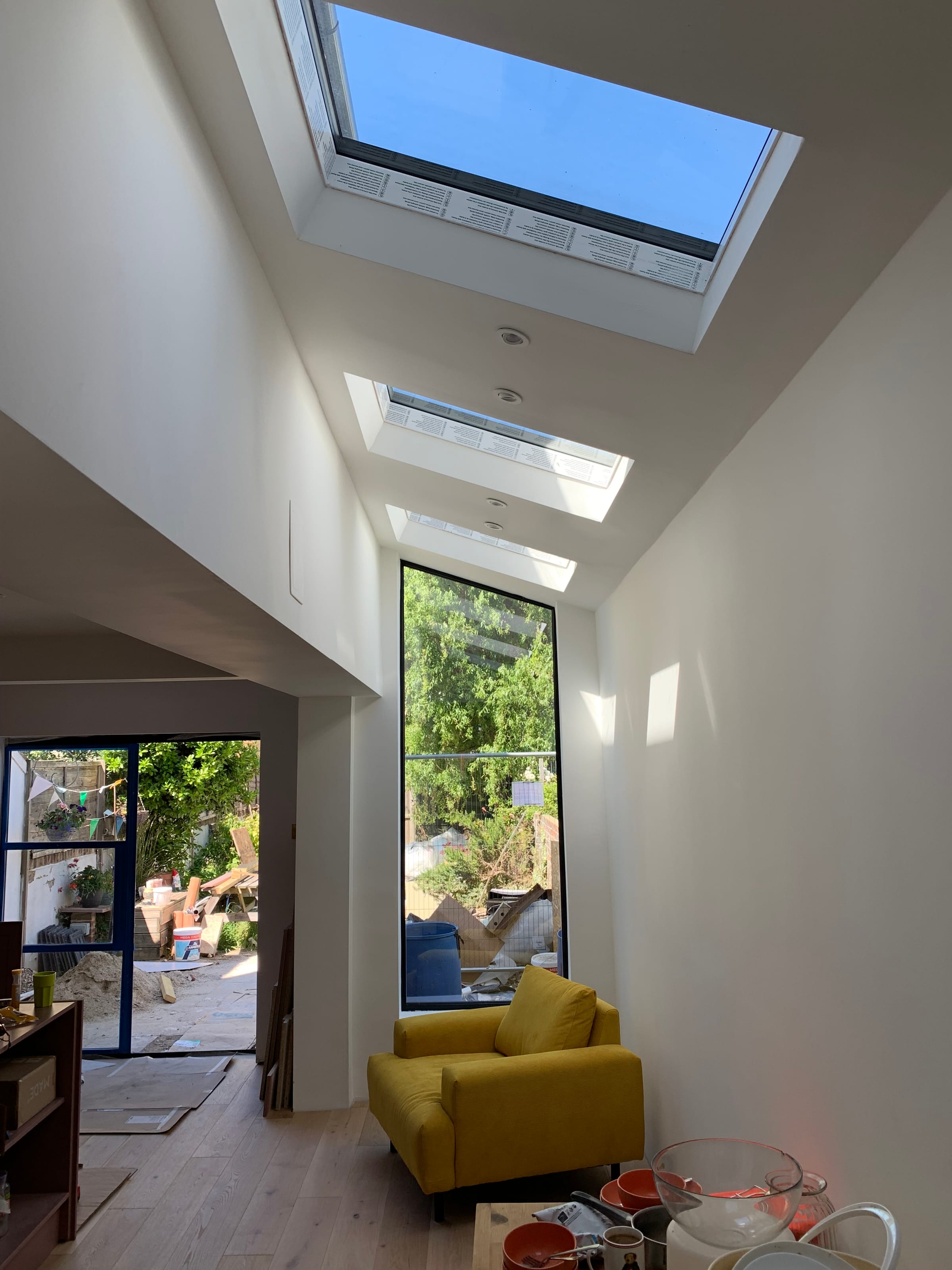 Row of roof lights flooding a house extension with natural light