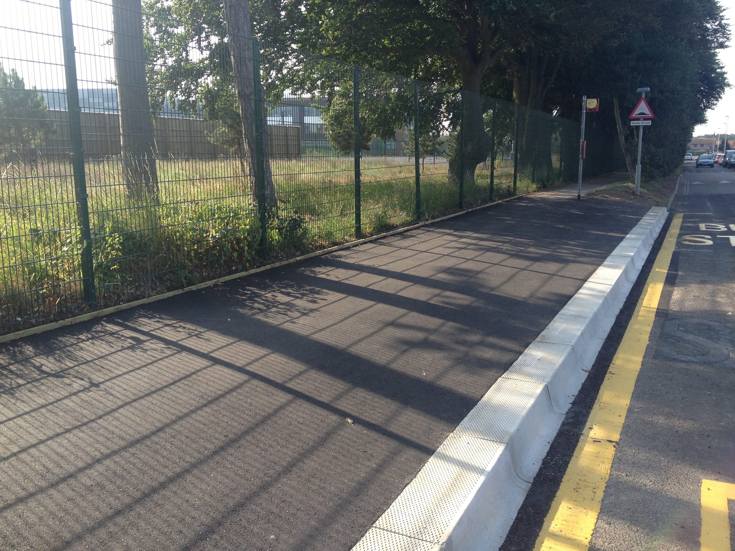Resurfaced tarmac footpath alongside a road