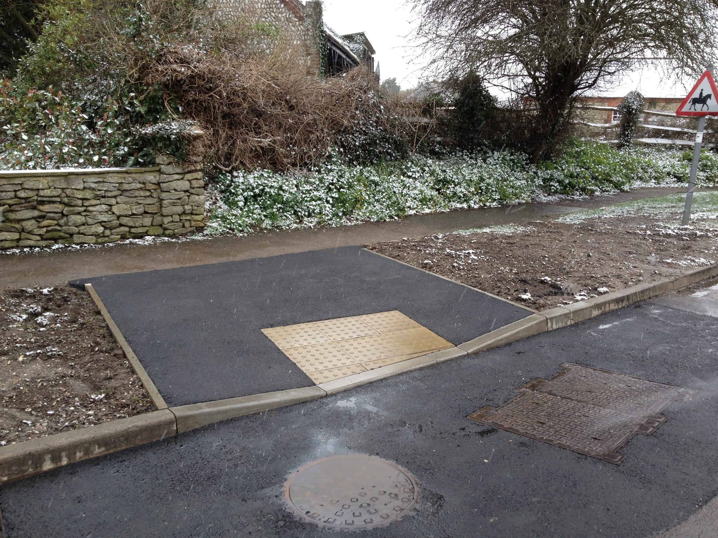 Tarmac footway crossing with tactile paving and new kerbs