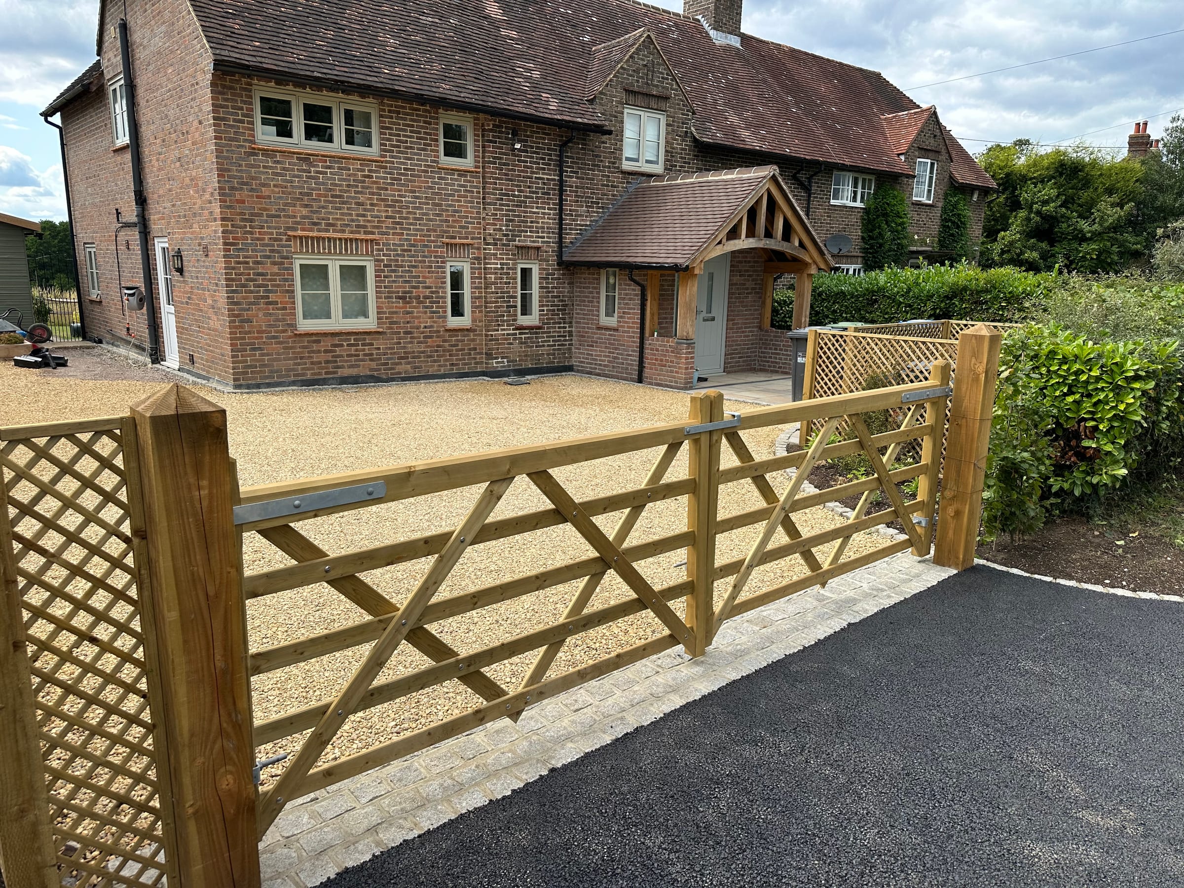 Resin gravel driveway with timber five-bar gate and fencing
