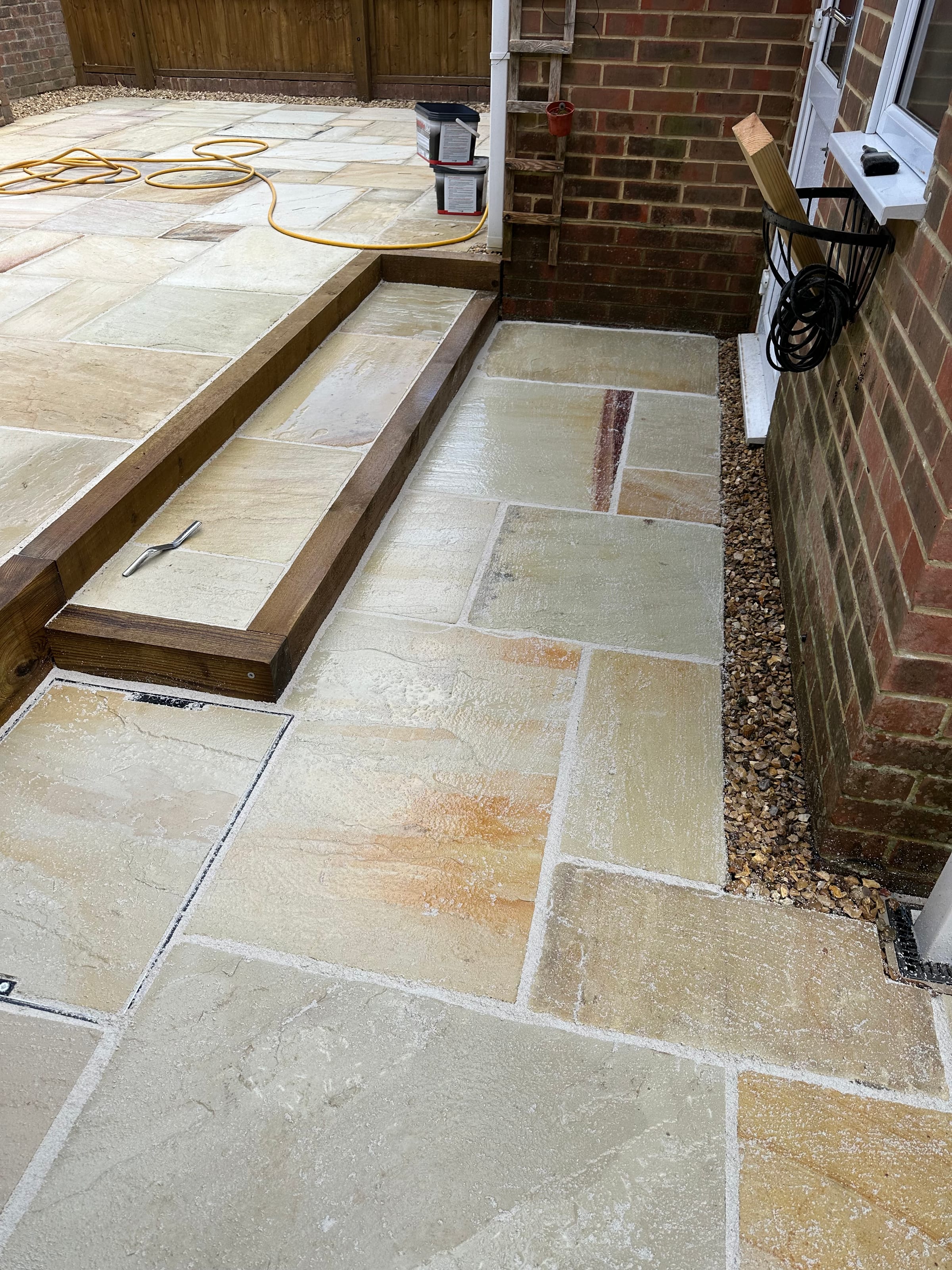 Raised patio step with recessed manhole cover detail