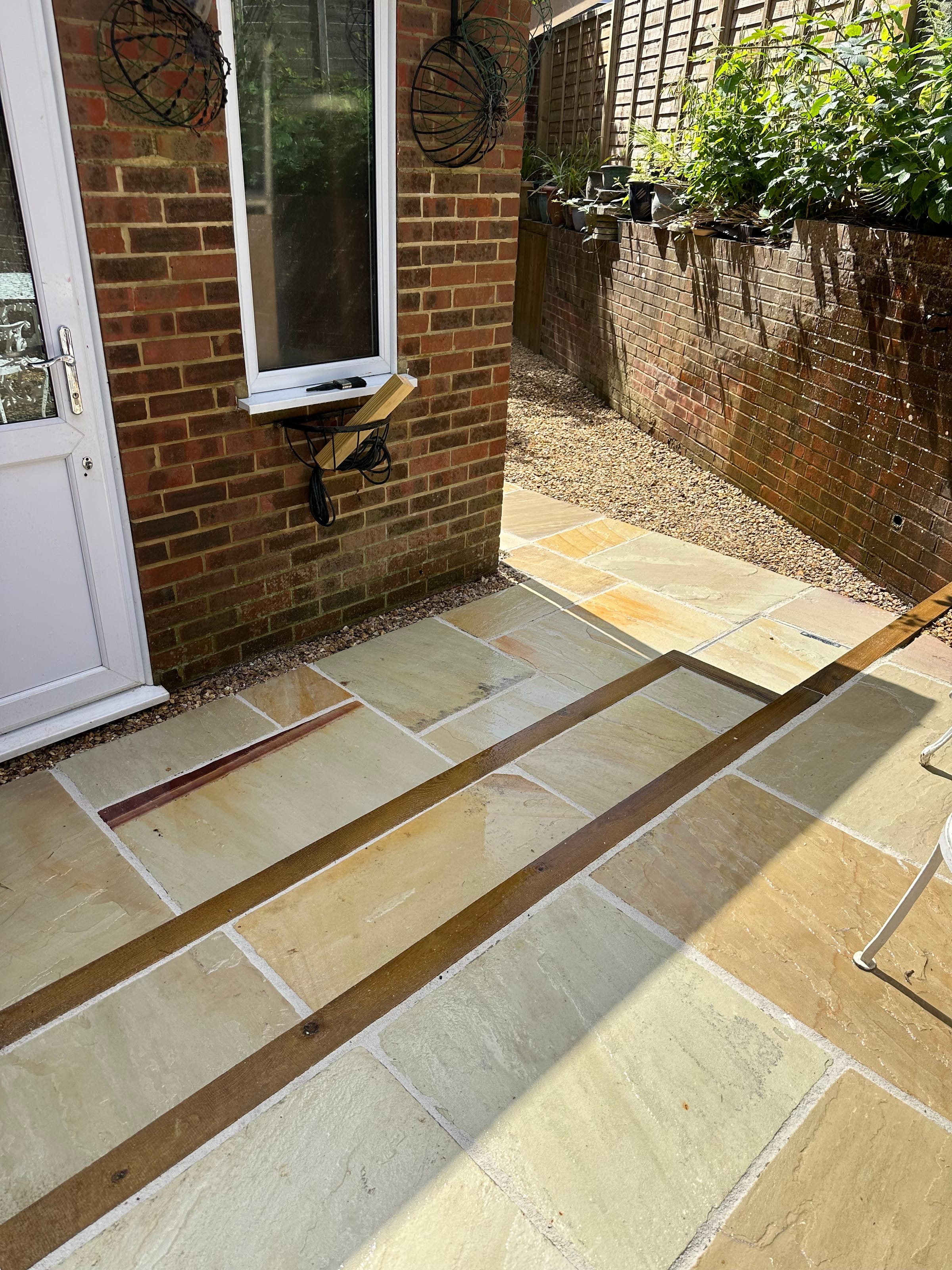 Patio threshold with timber-edged drainage channel