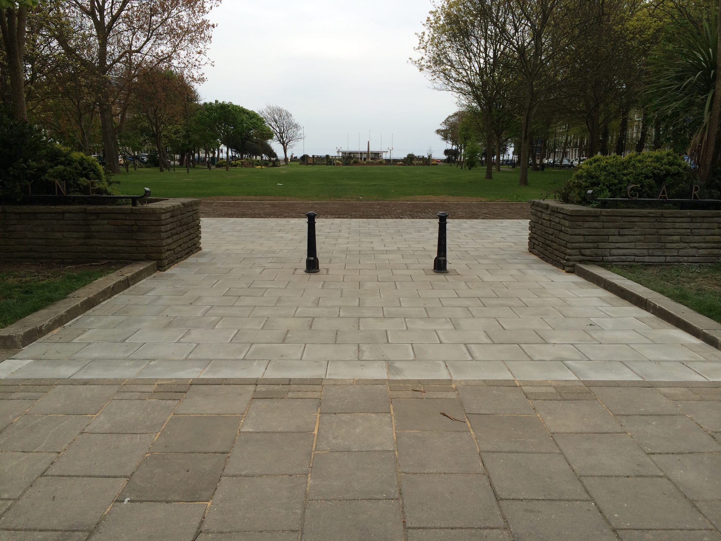 Paved plaza entrance to a seafront garden