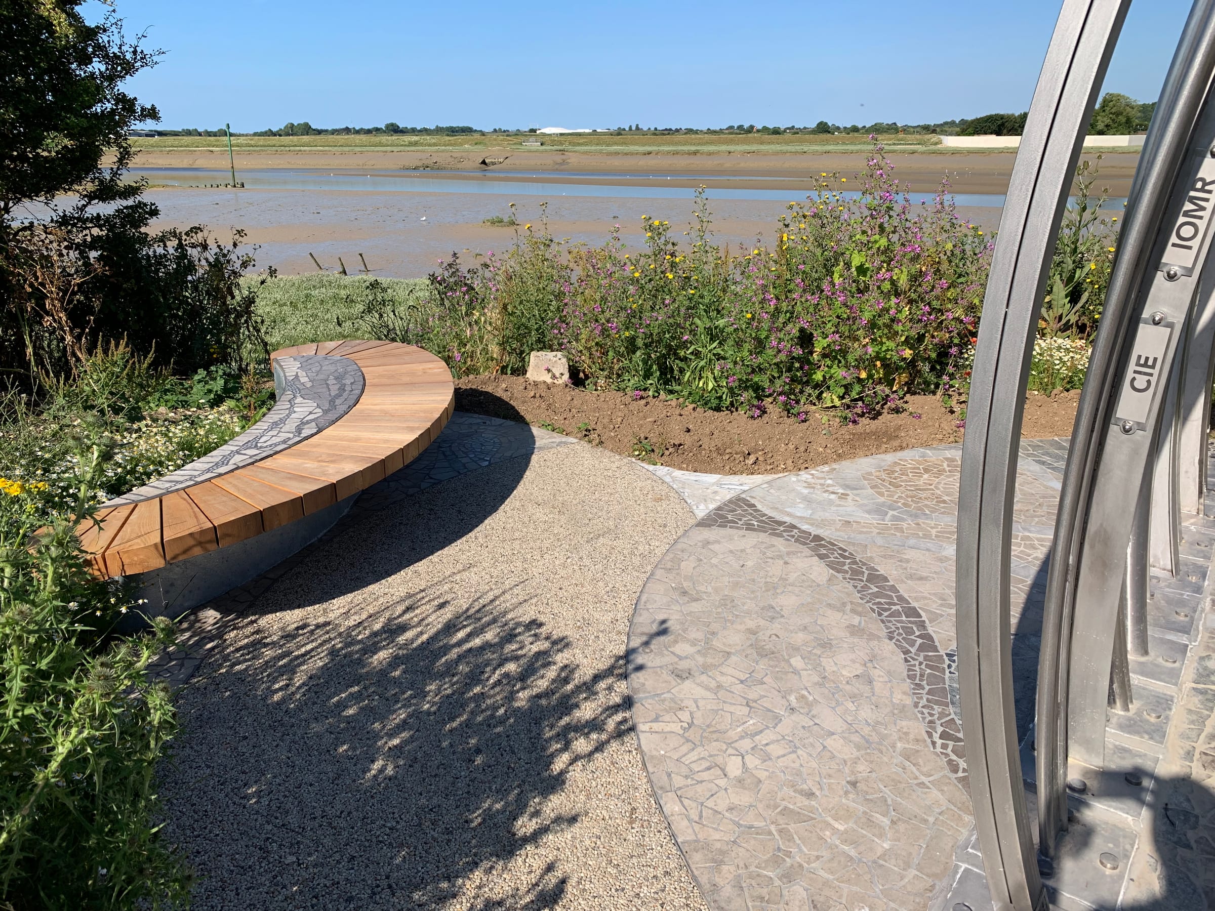 Curved sculptural bench and paving overlooking the estuary