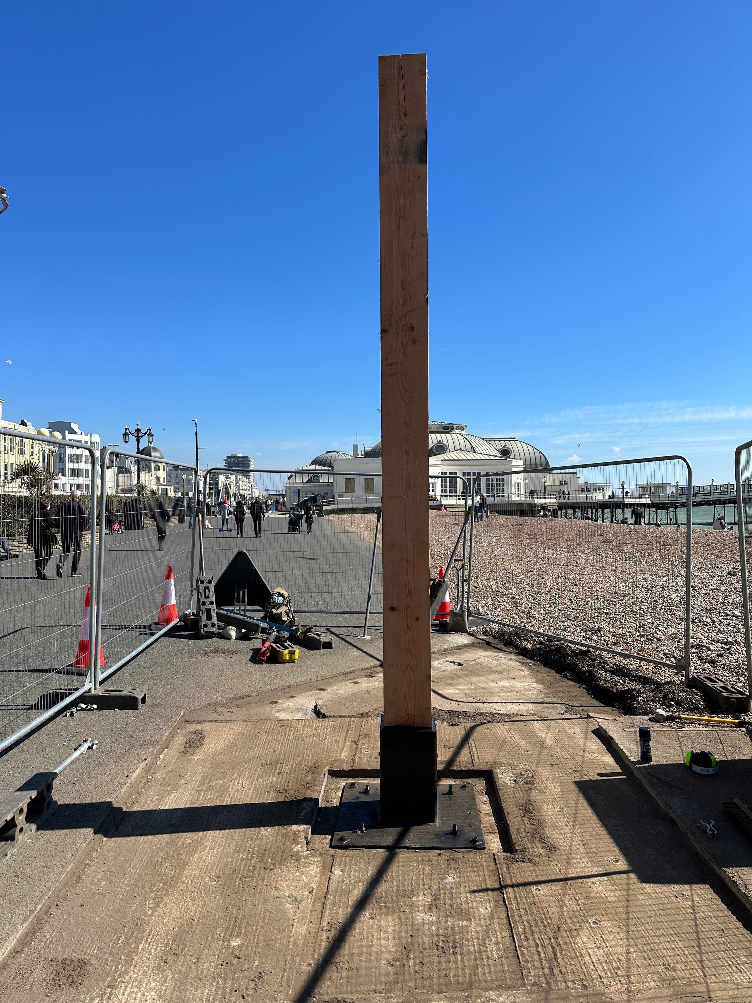 New timber post being installed on a seafront promenade